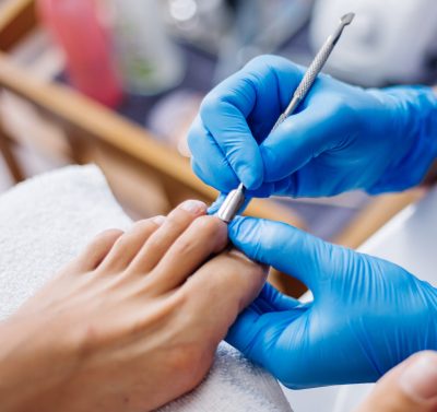 podolog wykonujacy zabieg w gabinecie podologicznym